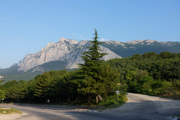 A steep mountain bend of a paved road. Auto travel.