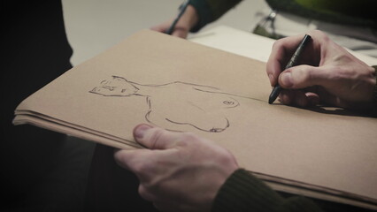 The painter draws a sketch on paper