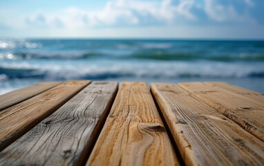 Fototapeta premium Close-up view of a wooden table set against the backdrop of the ocean, showcasing textures and colors of the wood and the water
