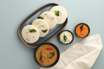 Idly sambar or Idli with Sambhar and green, red chutney. Popular South indian breakfast