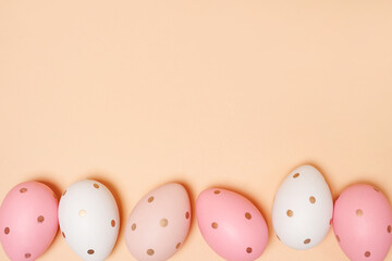 Fototapeta na wymiar Colorful Easter eggs on beige background with copy space