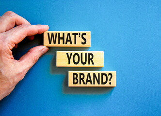Branding and what is your brand symbol. Concept words What is your brand on beautiful blocks. Beautiful blue background. Businessman hand. Business branding what is your brand concept. Copy space.