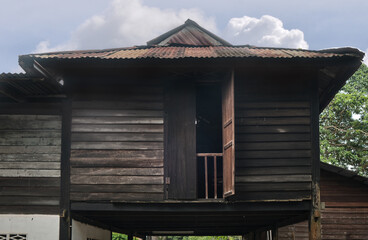 Ancient traditional wooden Malay house. An exciting glimpse into traditional Malaysian culture and architecture