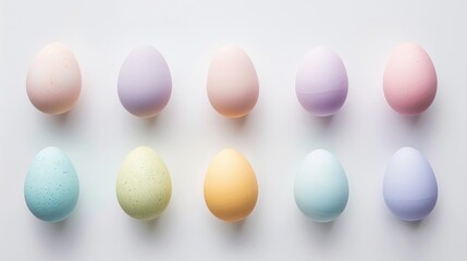 neat row of Easter eggs in soft pastel hues on a white background