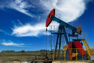 Oil industry. Oil rigs. oil pumps on a background of blue sky with clouds. Copy space.