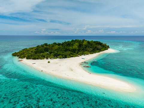 Beautiful beaches in Mantigue Island. Turquoise water and coral reefs. Camiguin, Philippines.