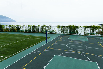 Fototapeta premium Outdoor Volleyball court with a net in the morning next to the sea.