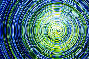Neon circle lines with empty copy space isolated on black background. Colorful led lights long exposure rotation photo. Eco shiny light glow. Cosmos space planet abstraction. Green vortex spiral.