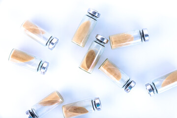 Vials, ampoules with dry probiotic, bifidobacteria inside on a white background, scattered...