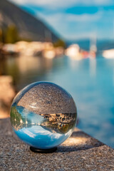 Crystal ball alpine autumn or indian summer landscape shot with boats and reflections at Lake Achensee, Pertisau, Eben am Achensee, Tyrol, Austria