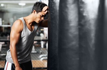Gym, fitness and tired with man and punching bag, low energy and performance mistake or disaster....