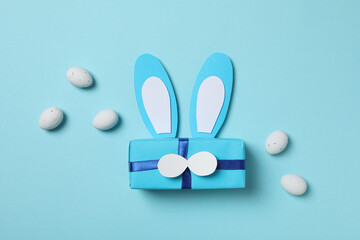 Blue gift box with bunny ears on a blue background