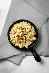 Skillet filled with macaroni and cheese with golden brown and bubbly