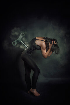 Conceptual Woman with a key in her back like a wind up doll to represent the oppression of women