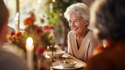 Happy senior woman laughing by female friend at dinner party