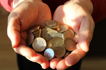 Turkish coins in the woman's palm. accumulation and savings.