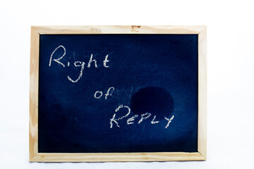 The term right of reply written by hand an a small blackboard isolated on a a clear background with...