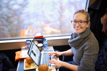 Woman, train and portrait with laptop for travel journey on commute as destination blogger,...