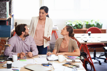 Group of colleagues, paper and brainstorming for presentation, creative and project planning. Workers, talking and documents for teamwork, ideas and solutions for strategy and collaboration in office