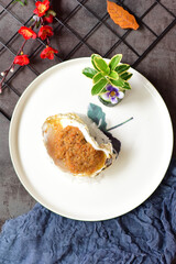 Garlic charcoal grilled oysters placed on a plate