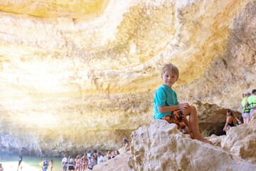 Children, enjoying Benagil, Portugal. Benagil Cave inside Algar de Benagil, famous sea cave in...