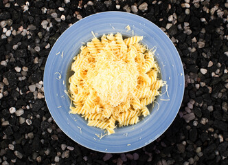 Pasta with Grated Cheese on Blue Plate