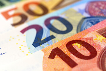 Euro Banknotes of 10, 20 and 50 euros, lying one on top of the other, close up.