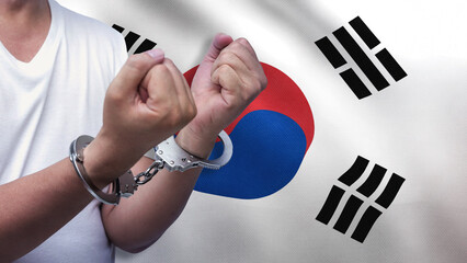 A man getting under arrest in South Korea. Concept of being handcuffed, detained, incarcerated and...