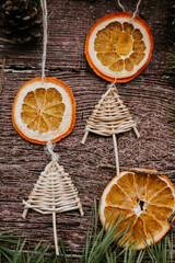 Christmas decoration, bees wax candle, dried orange slices and handmade Christmas tree ornament on wooden background