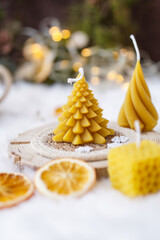Bees wax Christmas candles, lights in the background