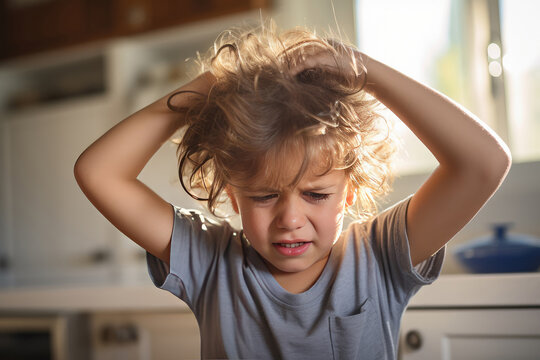 Little child scratching his head because of the lice
