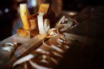 Hand planer with wooden sawdust. On a wooden background. High quality photo