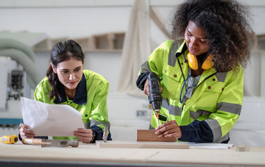 Industrial engineer wear safety reflective uniform working in heavy engineering factory. Confident...