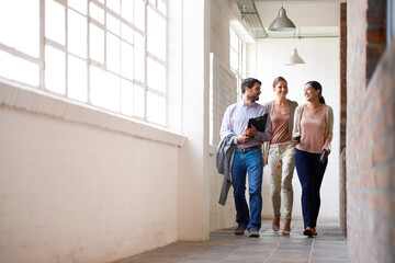 Business people, walking and team in discussion at office with coffee in startup at hallway. Smile,...