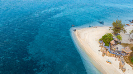Top view of sandy beach for summer vacation concept. Nature of the beach and sea in summer with sunlight, and light sand. The sea sparkles against the blue sky. Sandy Beach for summer vacationconcept.