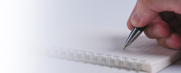 Ink Trails Capturing Thoughts with Pen and Notebook, a man hand using pen writing on paper notebook...