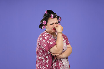 Asian woman with a mocking face. middle-aged Asian woman giving a mocking expression isolated on a...