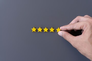 Hand arrange five star shape. Feedback, review, rating and customer experience concept