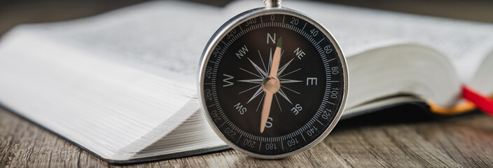 Book and compass on the table © Daniel