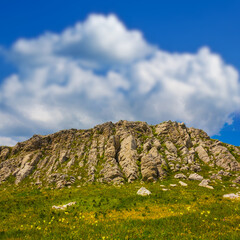 rocky mountain ridge under dense cloudy sky