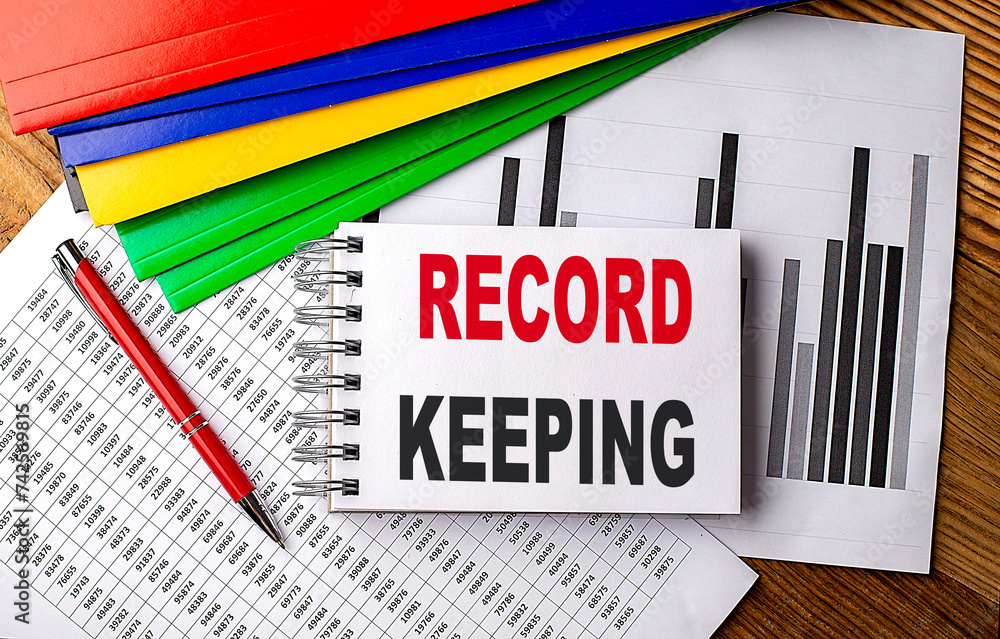 Aufkleber record keeping text on notebook with pen, folder on a chart background