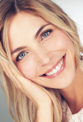 Naklejka premium Closeup, makeup and portrait of woman with smile for cosmetic, beauty and healthy skin for wellness. Happy, face and female person with hand for relaxing with skincare, dermatology or self care