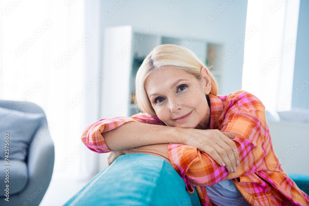 Sticker photo of cheerful attractive woman sit divan feel dreamy in new flat indoors