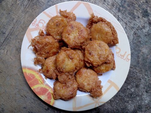 Perkedel kentang or mashed potato fritters. First, fry the potatoes first, once cooked, mash the potatoes and mix with some spices, then shape into rounds and fry with egg coating. Indonesian dish.