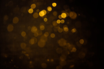Blurred photo with golden dots visible glittering, shining brightly look and feel luxurious...