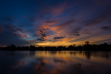 Nature silhouette twilight sky on lagoon with light reflectio