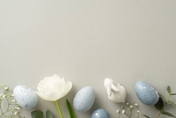Spring celebration theme in top view photo featuring slate greyish eggs, a bunny statuette,...
