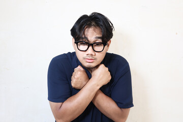 Young Asian man feel dizzy and feverish, isolated on white background
