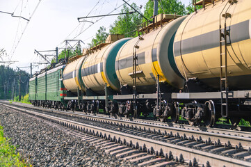 Fototapeta na wymiar Transportation of petrochemical products in a railway tank. The wagons are pulled by two locomotives. Transportation of petroleum products by rail. Wagons with liquefied gas.