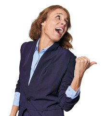 Mid-aged Caucasian businesswoman in blazer points with thumb finger away, laughing and carefree.